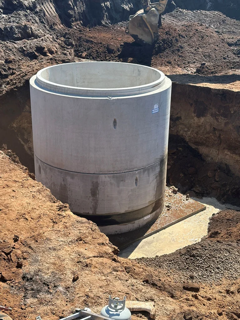 Image a pre-cast manhole being installed